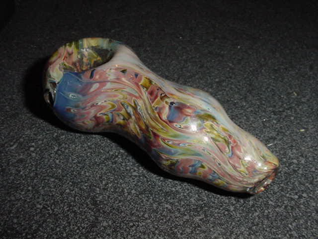 This one, a friend made way back in the day when he was first learning to blow glass.  He would kill me if he knew I posted it.  I call it my mutant spoon because it's all misshapen and has lots of tiny air bubbles in it.  Nice try though.