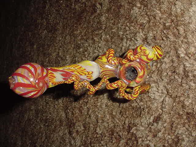 This is a real nice bubbler my friend made for me on my B-day.  It has a  trippy shroom on the side.  Lots of ribbions.  Lots of intense inside work. 