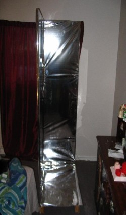 so i went to a thrift store and found this giant wardrobe for $45. i had to take it appart to get it into my appartment but while putting it back together i lined the entire thing in the same reflective paper as before, check it out