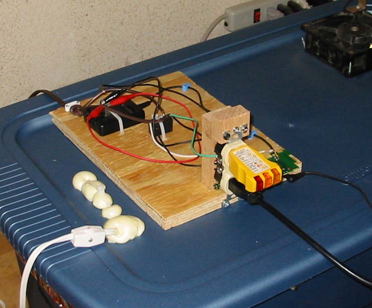 To use the thermostat, I am putting 5V across it that triggers a relay when the temperature causes the thermostat to turn on.  That relay controls a 120V outlet that I've hooked up to a 100W light bulb inside the growbox that will raise the temperature inside until the thermostat clicks off.